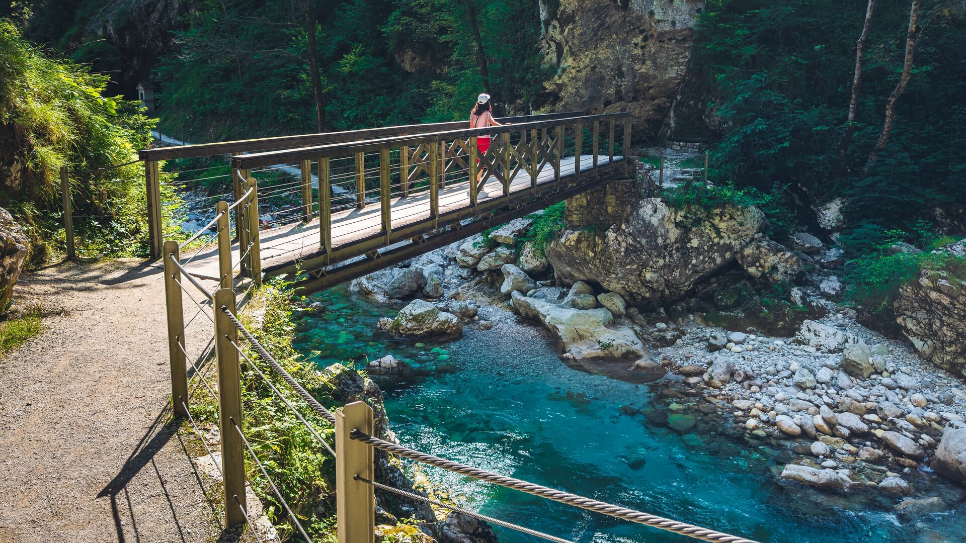 A woman crosses a bridge in Tolmin Gorge, Slovenia