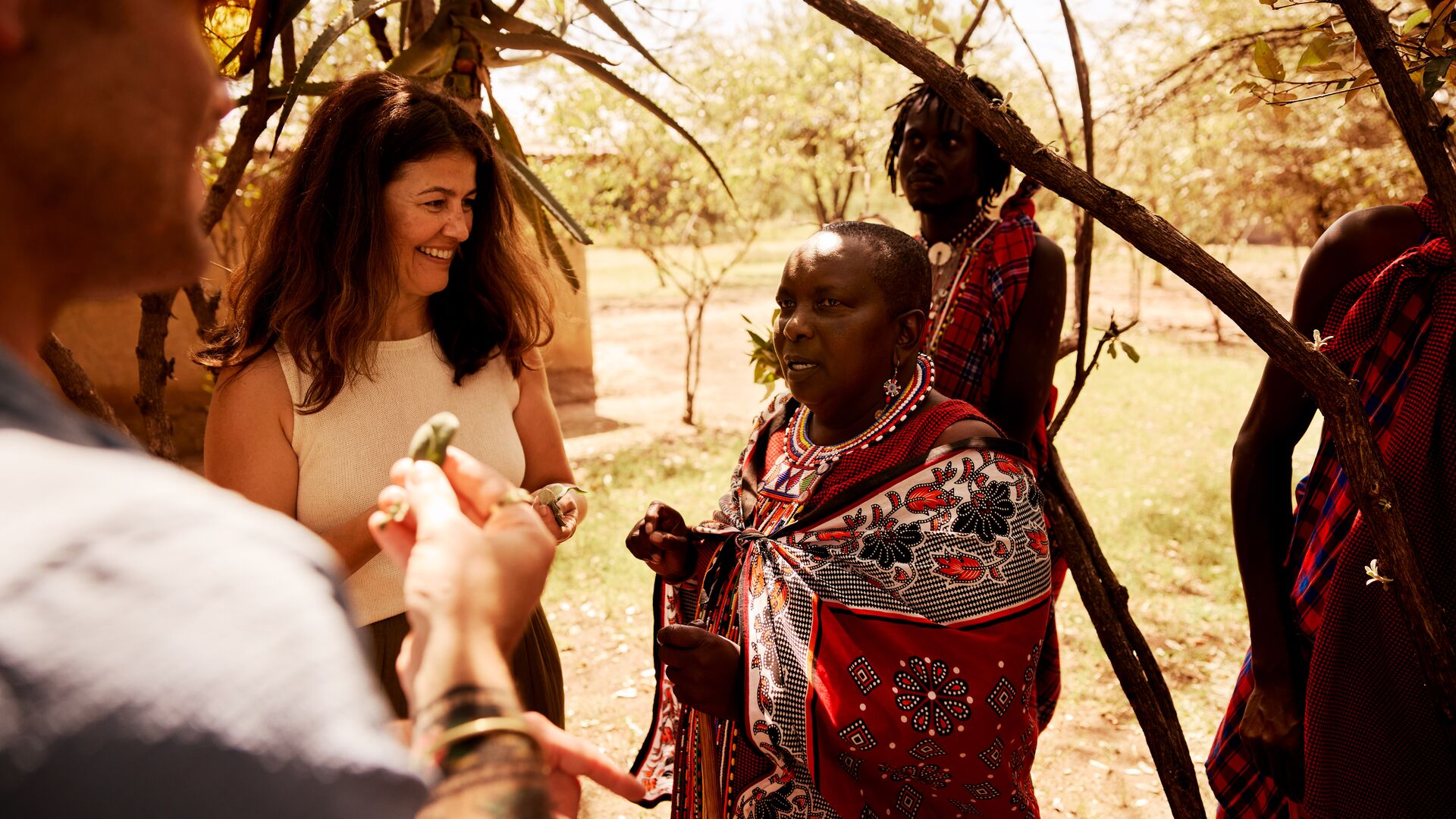 Travellers learn about Maasai culture and tradition during visits with Intrepid Travel.