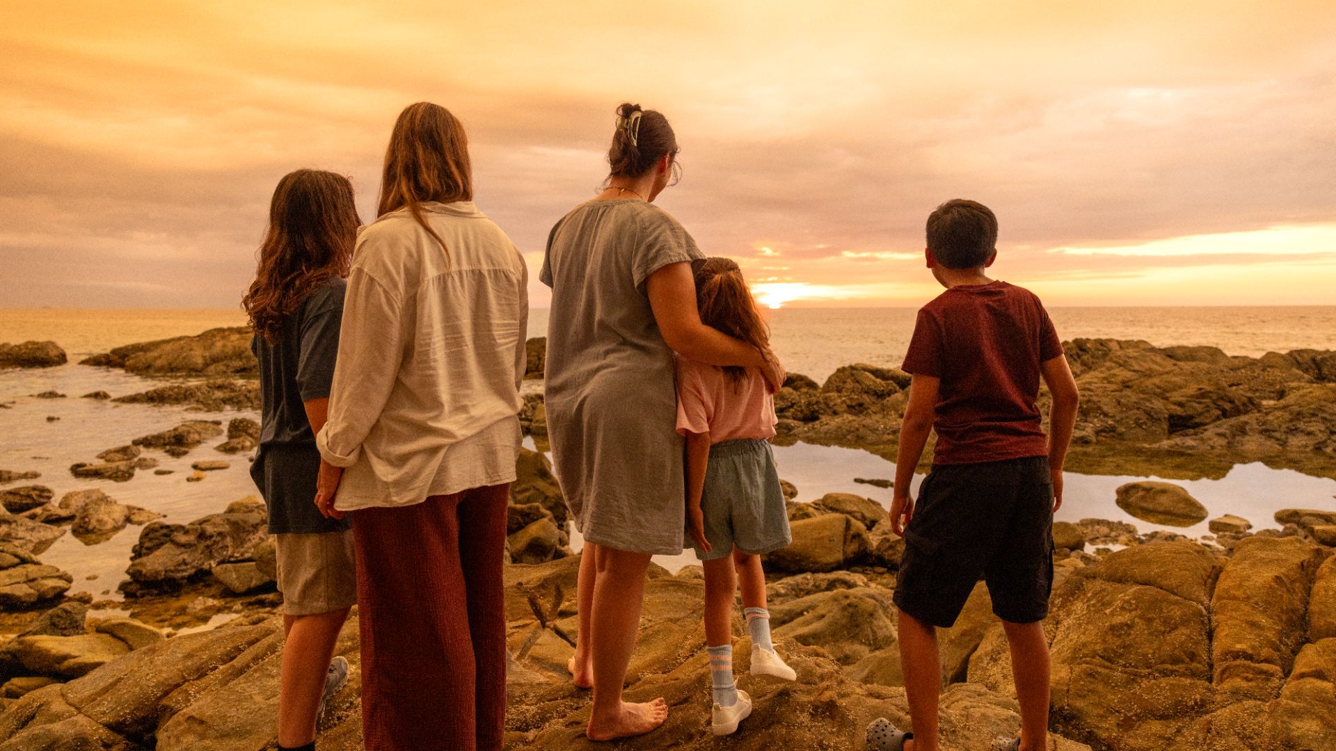 A family group on the beach in Borneo with Intrepid.