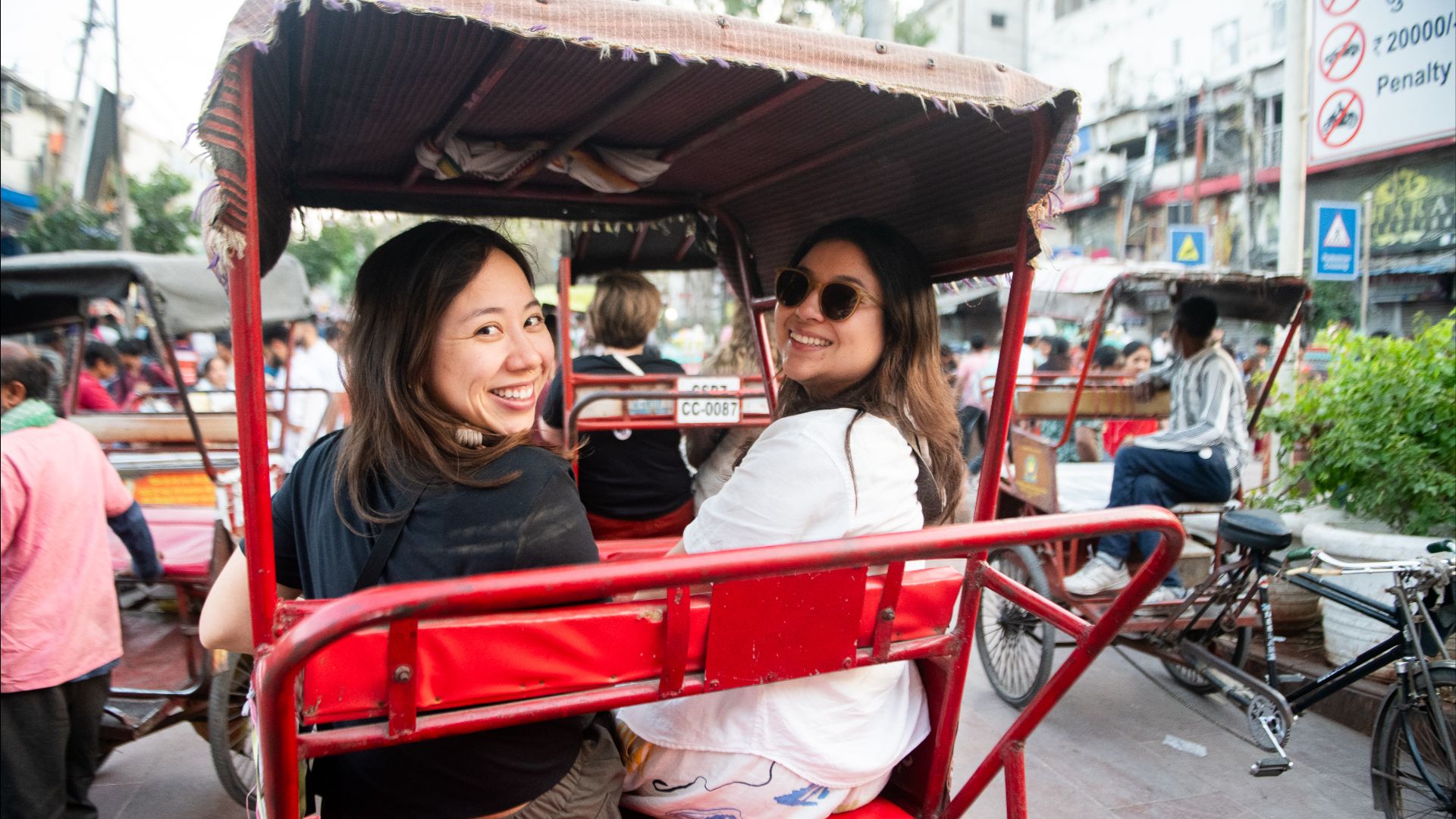 Female solo travellers with Intrepid on a rickshaw.