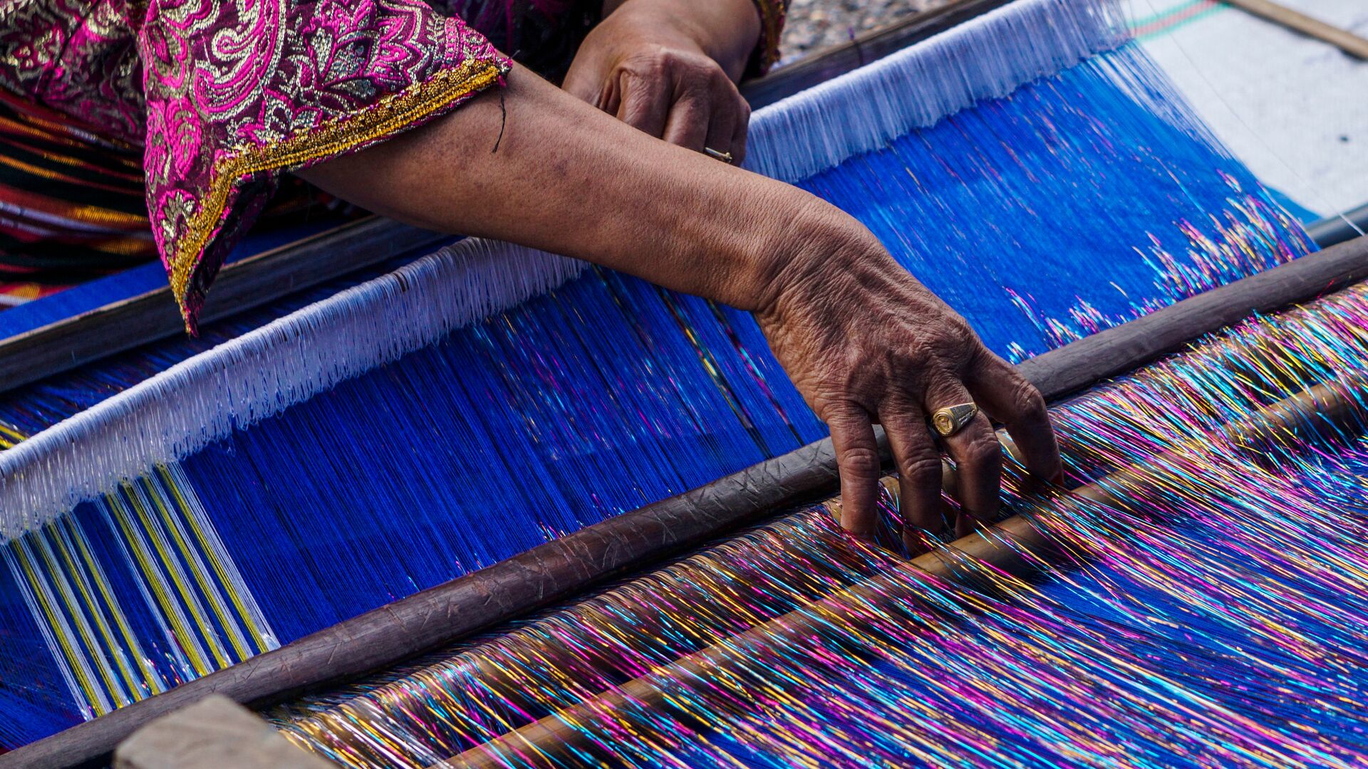 A woman weaves traditional textiles in Sumba, Indonesia.