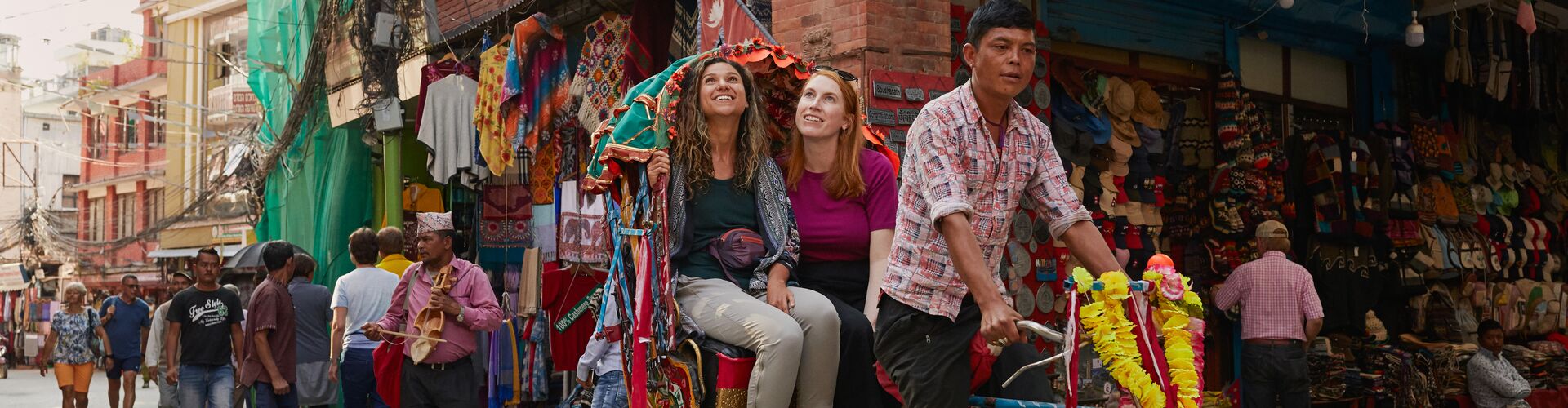 Two travellers on a rickshaw in Kathmandu in Nepal