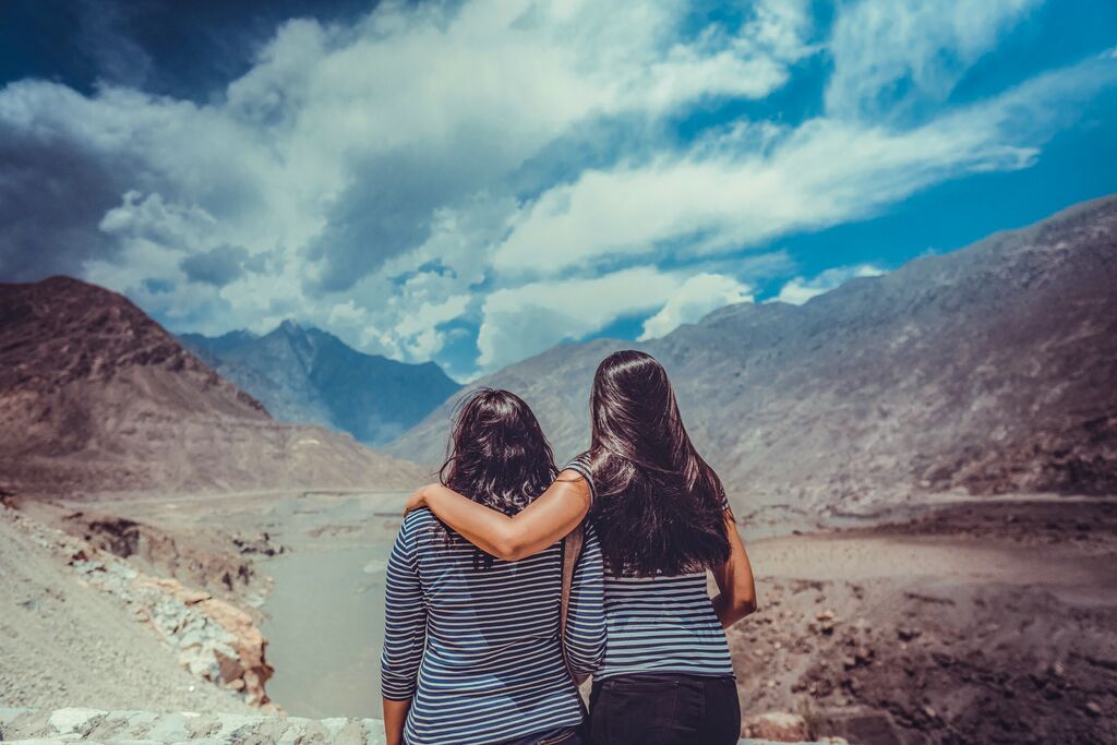 Two women staring out to the Hunza mountain ranges
