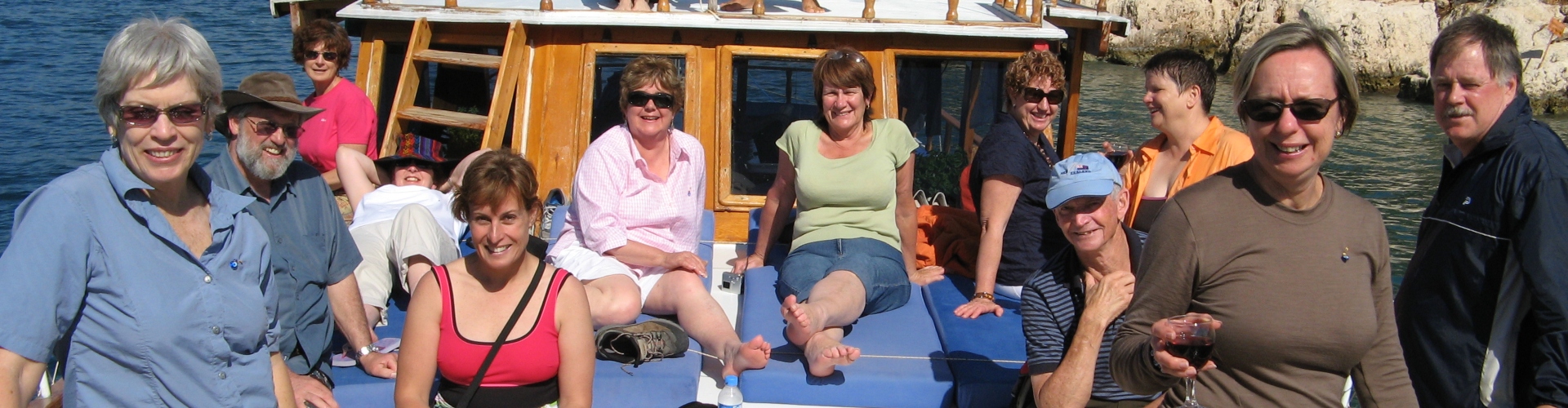 A group of people on the front of a sailing boat in Turkey 