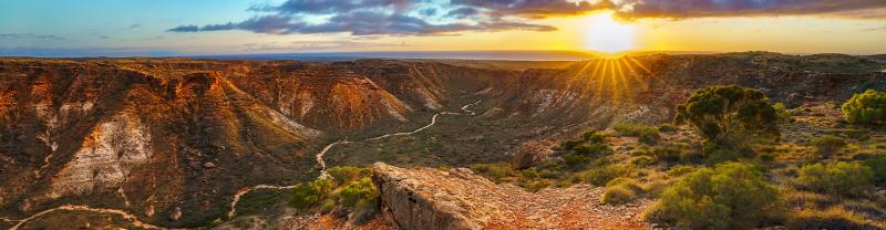 Sun showers at golden hour across Charles Knife Canyon, Exmouth, Australia