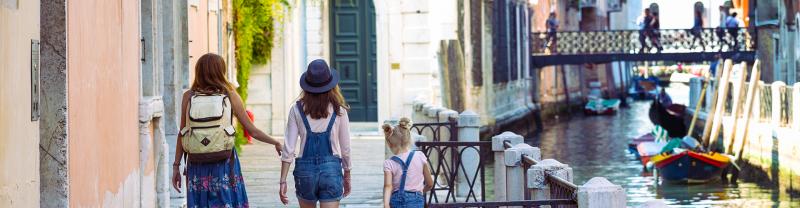 Mum and daughters walking around Venice. Italy