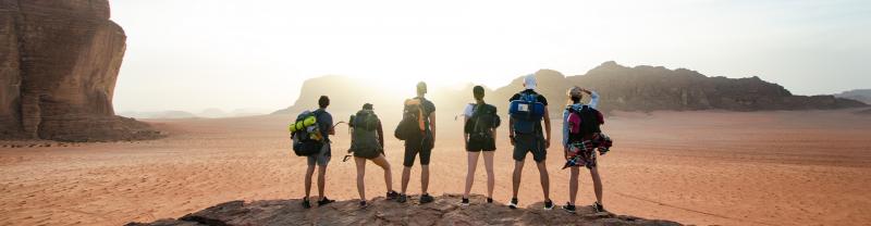 Group of hikers overlooking the desert in Wadi Rum, Jordan