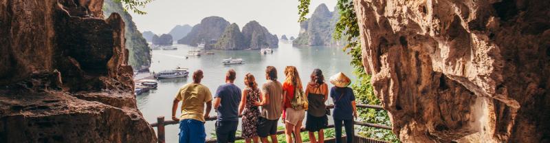 TVPHC - Group in cave overlooking boats in Ha Long Bay, Vietnam