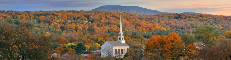 Stowe at sunset in Autumn with colorful foliage and community church in Vermont, USA