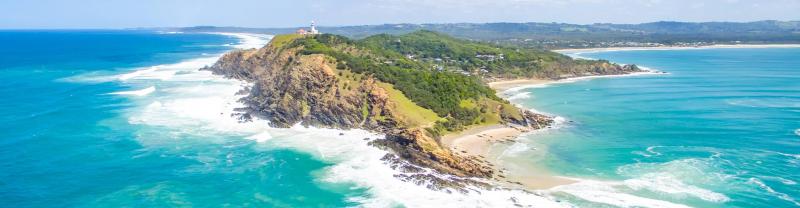 Aerial view of the cape of Byron Bay surrounded by blue ocean 