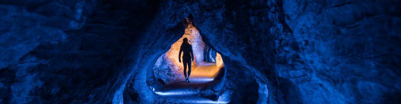 Dark luminescent cave with hues of blue and black