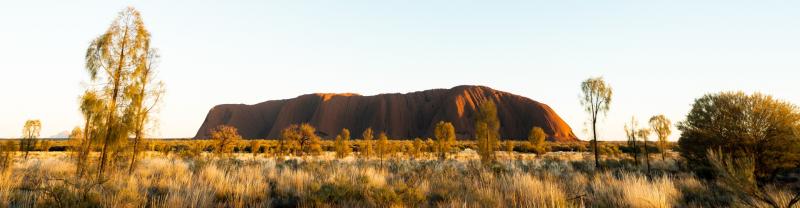 A scenic view of Uluru at sunrise