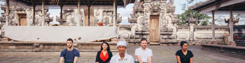 Travelers meditating at Lempuyang Temple in Bali