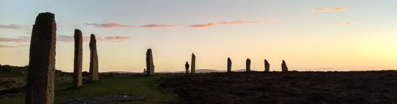 The Ring of Brodgar in Scotland silhouetted against a sunset