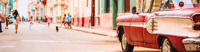A classic car cruising the colourful streets of Havana, Cuba