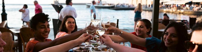 4 travellers enjoy some drinks in Crete, Greece