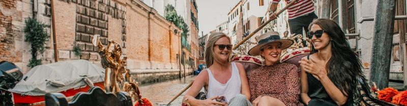 Friends enjoy a Gondola ride in Venice, Italy