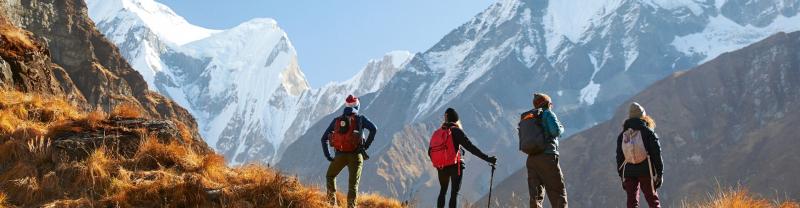 Four hikers admiring the views of the mountains on the Annapurna Base Camp trek