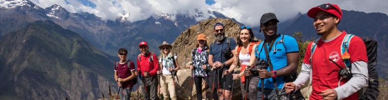 A group of hikers standing at a high altitude point along the Choquequirao Trek in Peru