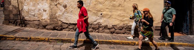 A group of travelers walking the streets of Cusco in Peru 