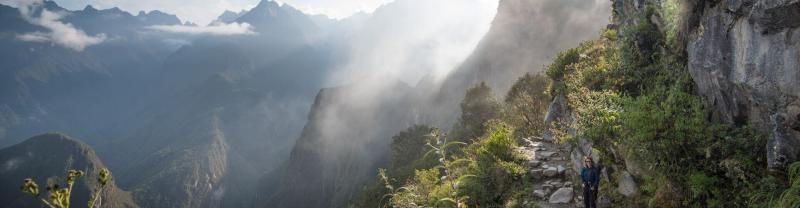 Two hikers walking on the Inca Trail path to Machu Picchu