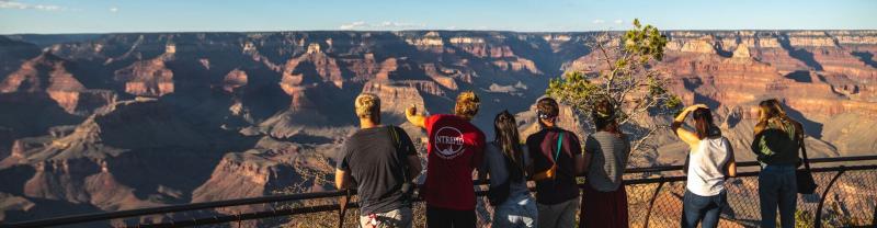 Group looking over the Grand Canyon in Arizona, United States