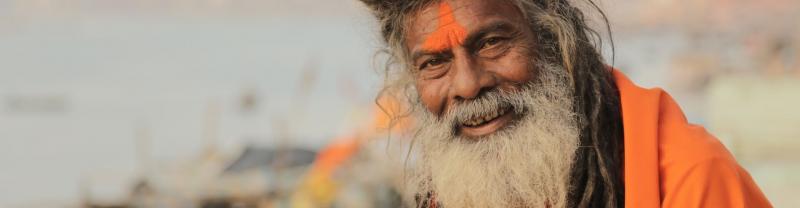 A holy man smiling by the Ganges in Varanasi