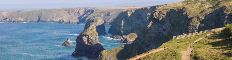 Waves crashing beneath the cliffs of the Cornish Coast