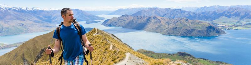 A hiker at the summit of Mount Aspiring in New Zealand
