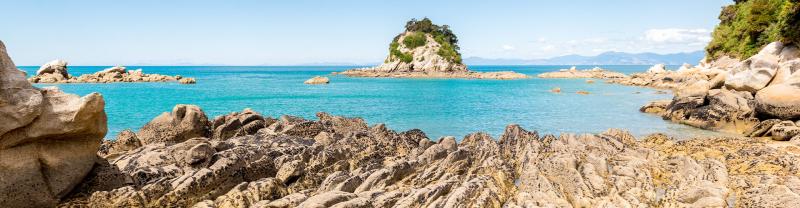 A shot of the beach on a sunny day in Abel Tasman National Park, New Zealand. 