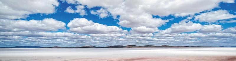 White clouds and blue skies over an outback Lake Eyre in South Australia