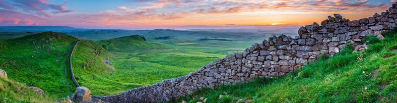 A scenic view of Hadrian's Wall as sunset