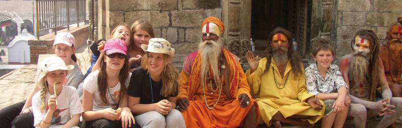 Children sit with Indian men on an Intrepid travel trip