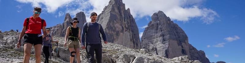 Travellers and a leader walking in the Italian Dolomites
