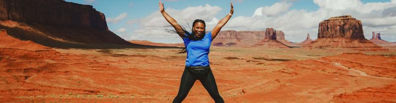 A traveler jumps for a photo in Monument Valley in Arizona