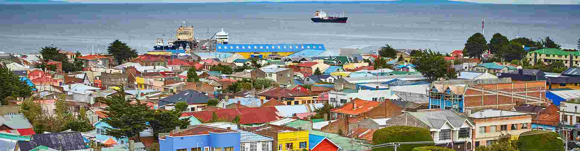 The colourful buildings of Punta Arenas with the bay area and a few large expedition ships in the background