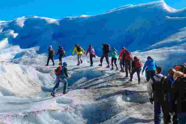 A group of travellers walking in the Perito Moreno Glacier as part of patagonia