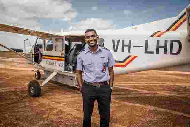 A smiling pilot out the front of his plane in Arnhem Land 