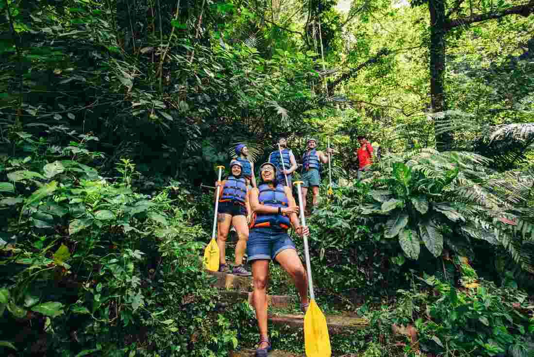 A group of travellers whitewater rafting in Bali