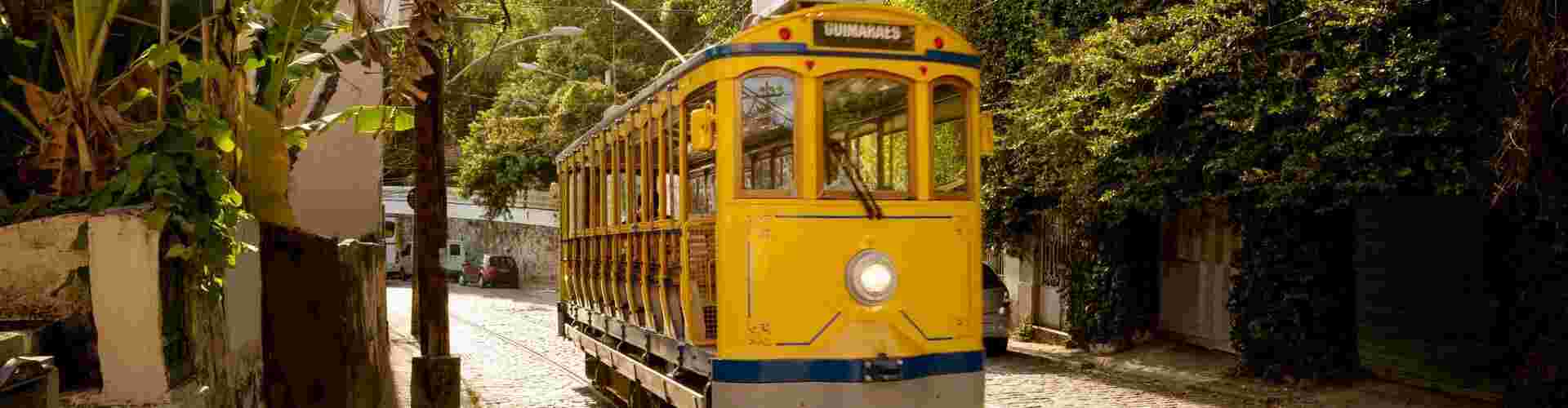 A yellow tramcar going down the street in Rio, Brazil