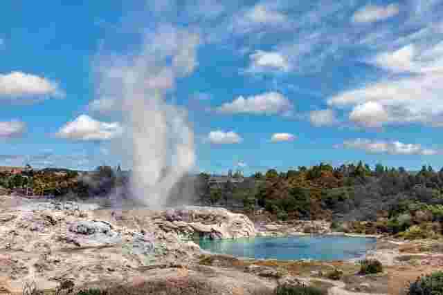 A geyser erupting in Punahou underneath a clear, blue sky 