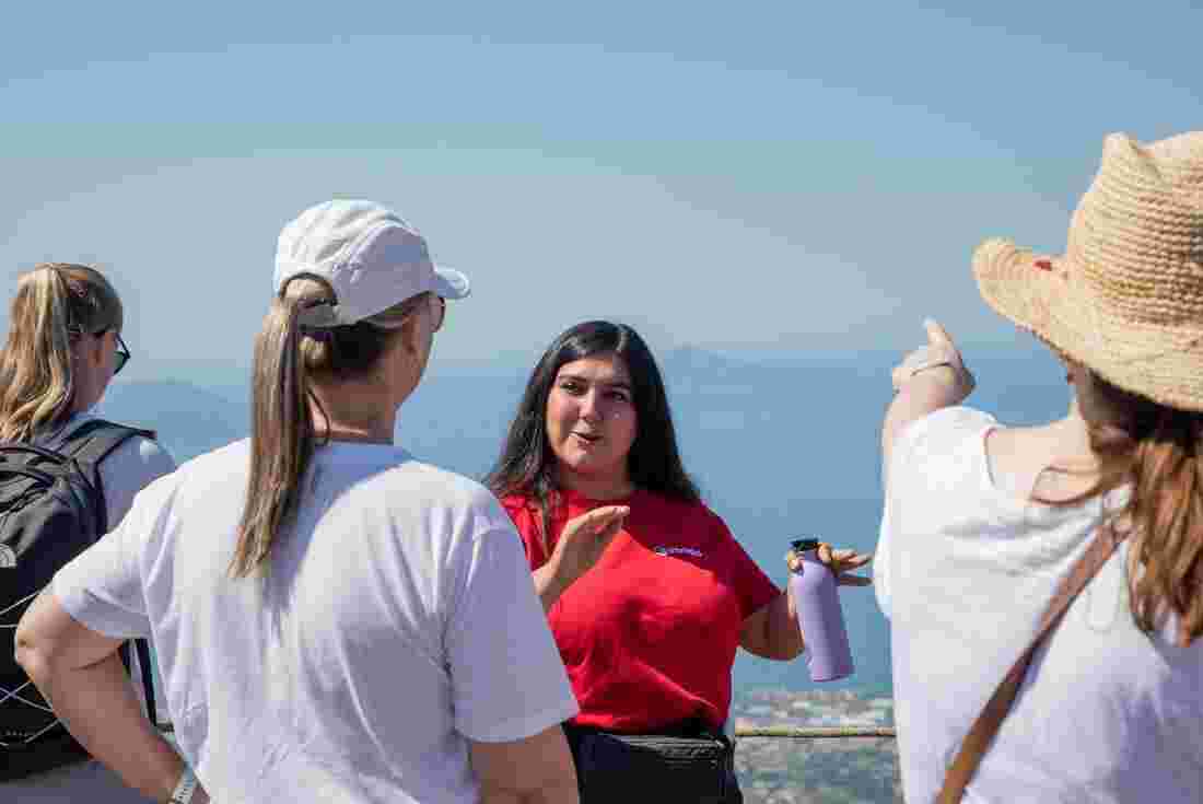 A leader talking with travelers on the Italian Coast