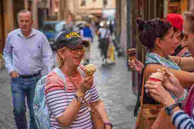 A group of travellers enjoying gelato on a hot day in Rome