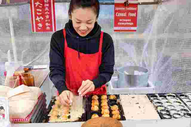 Local woman making traditional snacks at a market in Takayama 