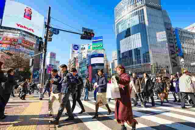 Crowds of people walking across Shibuya crossing in Tokyo 