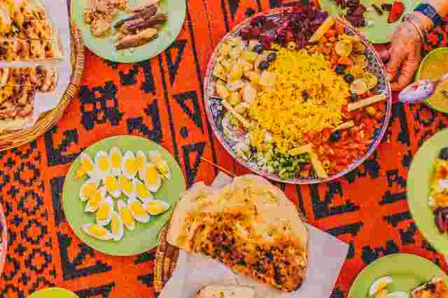 Aerial view of a table laden with traditional Moroccan dishes. 