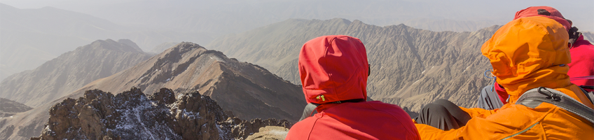 Travellers looking out over Toubkal Mountain in Morocco 