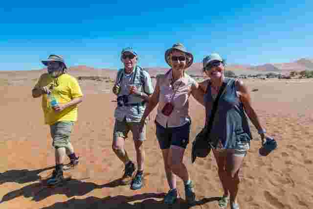 A group of travellers walking through the desert in Namibia