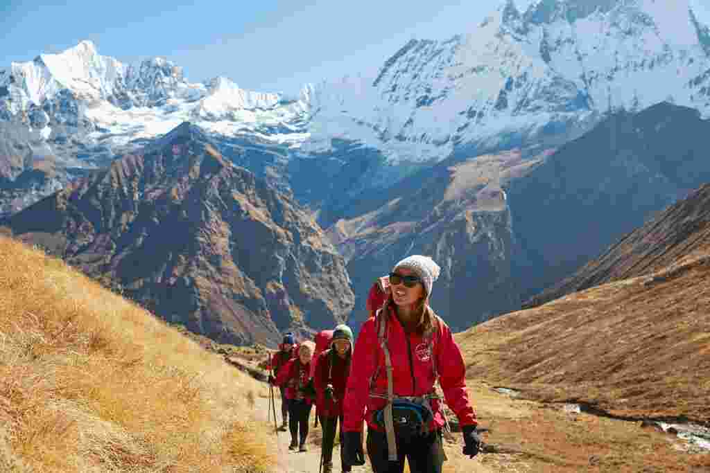 Female trekking leader leads a group in the Annapurnas, Nepal