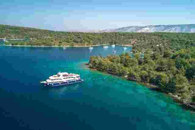 A boat cruising the turquoise Adriatic Sea in Croatia 